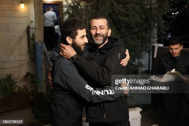Palestinian Khalil Al-Awar , former prisoner released from the Israeli jail in exchange for hostages freed by Hamas in Gaza, is greeted upon return...