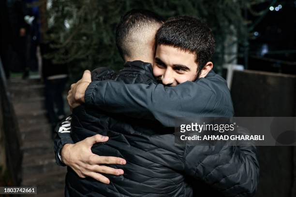 Palestinian Khalil Al-Awar , former prisoner released from the Israeli jail in exchange for hostages freed by Hamas in Gaza, is greeted upon return...