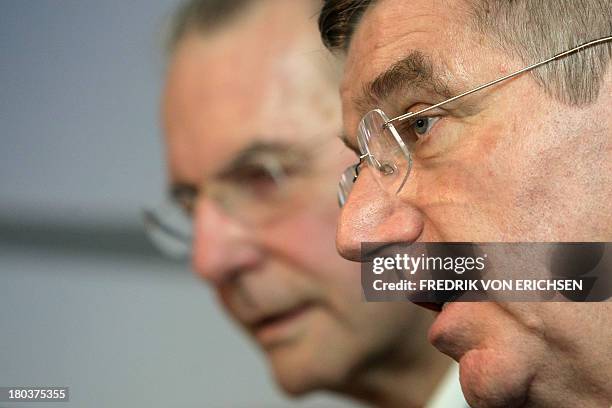 Thomas Bach and Jacques Rogge , the 0new president and the outgoing presidents of the International Olympic Committee , address the media upon their...