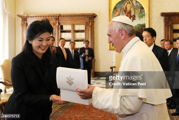 Pope Francis exchanges gifts with Thailand's Prime Minister Yingluck Shinawatra during an audience at his private library on September 12, 2013 in...