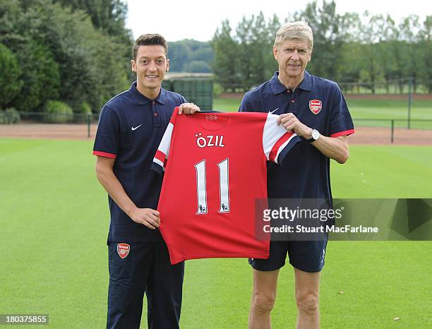 Arsenal manager Arsene Wenger with new signing Mesut Oezil at London Colney on September 12, 2013 in St Albans, England.