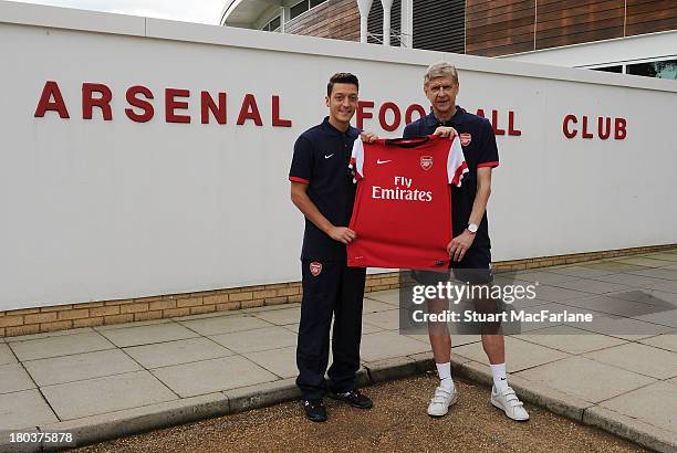 Arsenal manager Arsene Wenger with new signing Mesut Oezil at London Colney on September 12, 2013 in St Albans, England.