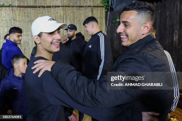 Palestinian Mohammed Al-Awar , former prisoner released from an Israeli jail in exchange for hostages freed by Hamas in Gaza, is greeted upon return...
