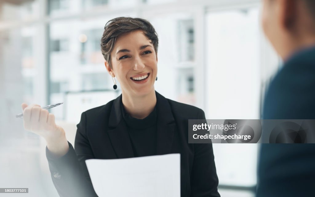 Businesswoman, face and smile with document in office for meeting, planning or collaboration. Female manager, hr and interview with pen for report, review or note with team for strategy with feedback