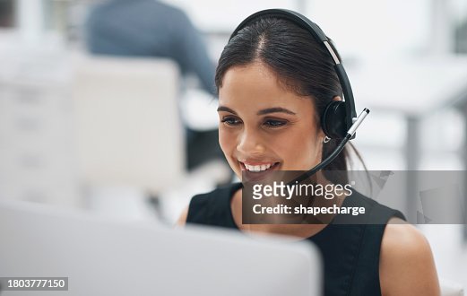 Happy woman, face and headphones in call center for customer service, telemarketing or support at office. Female person, consultant or agent smile with headset for online advice or help at workplace