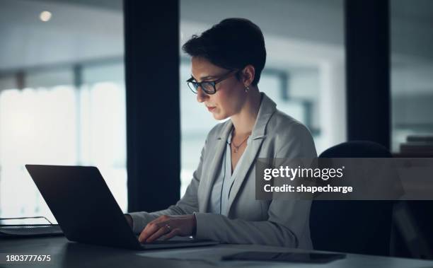 business woman, computer and typing at night for stock market research, trading software or investment in office. professional analyst or trader reading with glasses on laptop and online management - night suit stock pictures, royalty-free photos & images