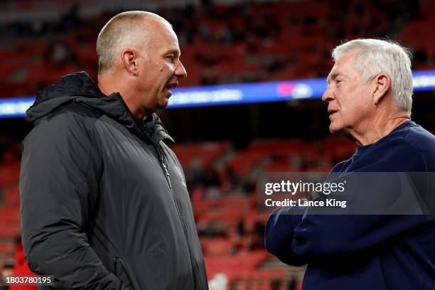 Head coach Mack Brown of the North Carolina Tar Heels talks with head coach Dave Doeren of the NC State Wolfpack prior to the game at Carter-Finley...