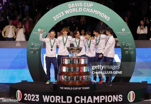 The members of team Italy celebrate winning the Davis Cup tennis tournament after beating Australia at the Martin Carpena sportshall, in Malaga on...