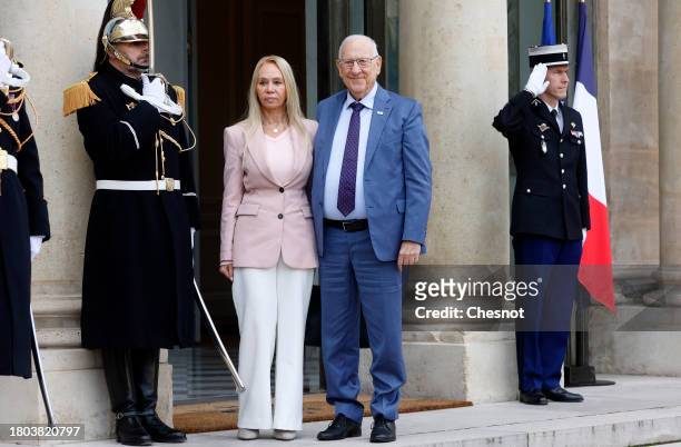 Former Israeli President Reuven Rivlin and his companion Sarit Tzemach pose for photographers prior to a meeting with French President Emmanuel...