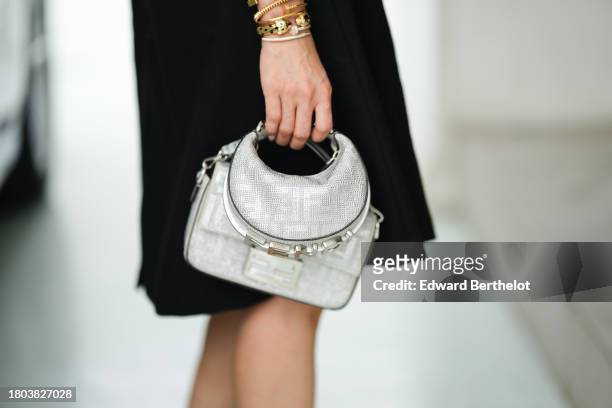 Heart Evangelista wears silver / gray shiny monogram printed Fendi bags, during a street style fashion photo session, on November 18, 2023 in Manila,...