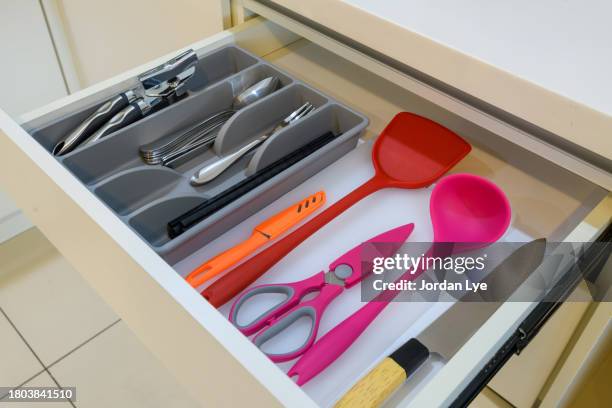 utensils in kitchen drawer - küchenzubehör stock-fotos und bilder
