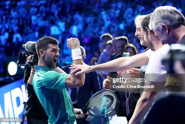 Novak Djokovic of Serbia celebrates to his team after victory against Jannik Sinner of Italy in the Men's Singles Finals between Jannik Sinner of...