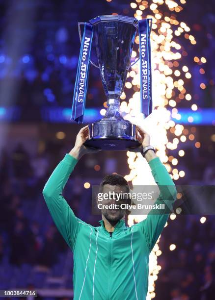 Novak Djokovic of Serbia lifts the Nitto ATP Finals trophy after victory against Jannik Sinner of Italy in the Men's Singles Finals between Jannik...