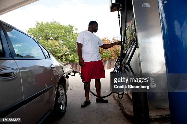 Azadia Boyd prepares to buy fuel at a gas station in Peoria, Illinois, U.S., on Wednesday, Sept. 11, 2013. Gasoline climbed in New York trading as...