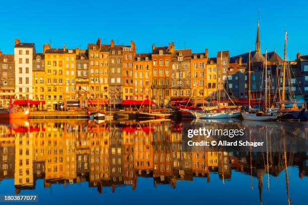 harbor and row houses in honfleur normandy france at sunrise - normandy stock pictures, royalty-free photos & images