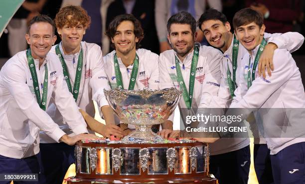 The members of team Italy pose with the trophy as they celebrate winning the Davis Cup tennis tournament at the Martin Carpena sportshall, in Malaga...