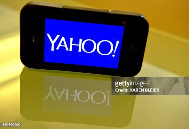 This September 12, 2013 photo illustration shows the newly designed Yahoo logo seen on a smartphone. Yahoo has refreshed its logo for the first time...
