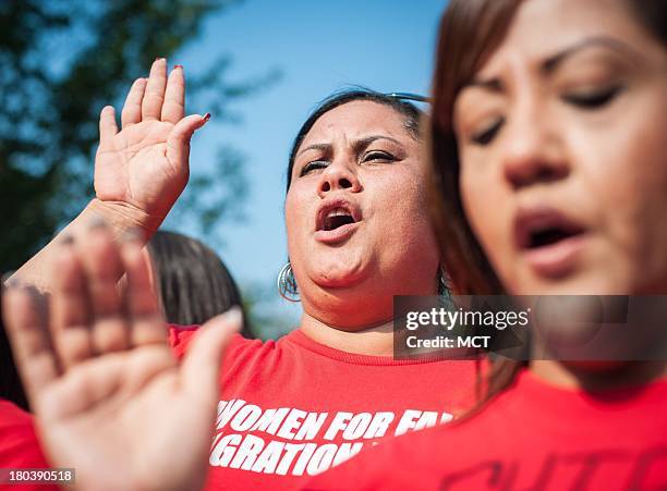 Leisha Carrasquillo Acosta of Charlotte, North Carolina, takes an oath to fight for immigration reform during the rally in front of the Capitol in...