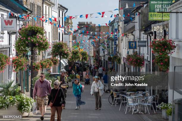 General view of people walking past shops along Causewayhead on September 18, 2023 in Penzance, Cornwall, England.