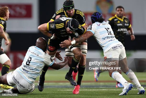 La Rochelle's Irish lock Ultan Dillane fights for the ball with Racing 92's French number eight Jordan Joseph and Racing 92's New Zealand centre...