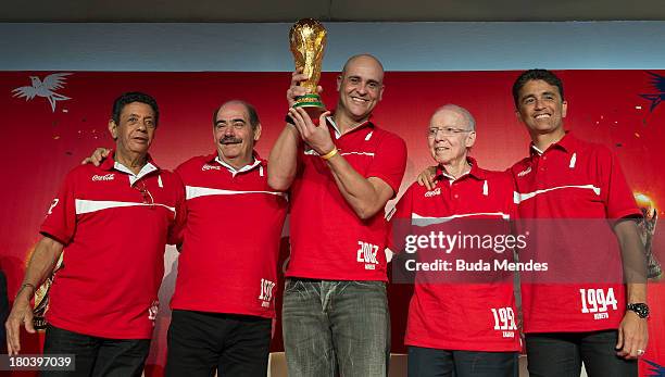 Brazilian FiFA World Cup winners Amarildo, Rivelino, Marcos, Zagallo and Bebeto pose with the FIFA World Cup Trophy during a press conference at the...