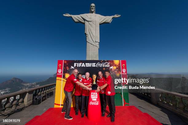 Brazilian FIFA World Cup winners Marcos, Amarildo, Zagallo, Rivelino and Bebeto pose with the trophy during the official launch of the Global FIFA...