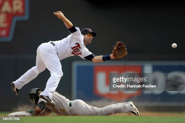 Coco Crisp of the Oakland Athletics steals second base as Brian Dozier of the Minnesota Twins fields the ball during the fifth inning of the game on...