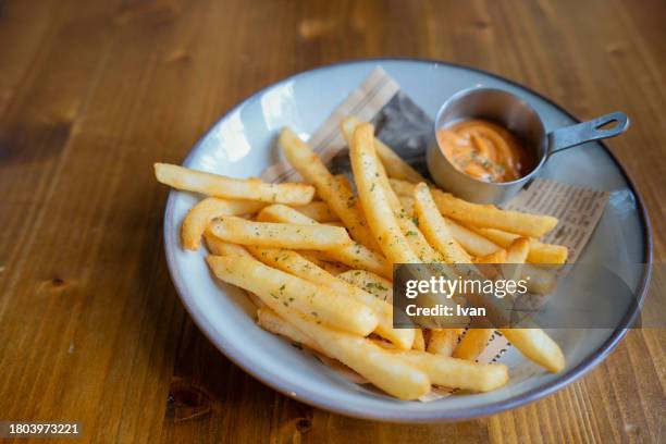 french fries with ketchup and mayonnaise on rustic wooden table - frite four photos et images de collection