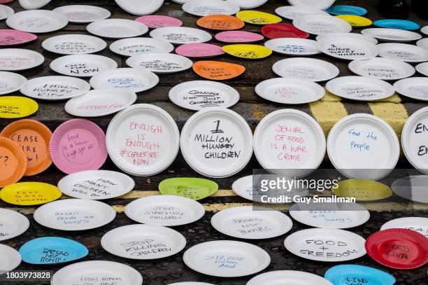 Activists make a symbolic protest outside the conference with empty plates to represent food shortages for children in Gaza at Lancaster House on...