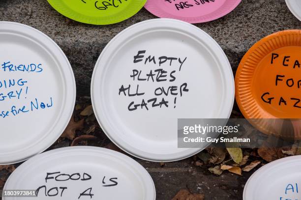 Activists make a symbolic protest outside the conference with empty plates to represent food shortages for children in Gaza at Lancaster House on...