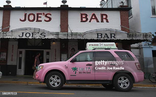 Five 6's Taxi drives past Sloppy Joe's Bar on Duval Street on September 12, 2013 in Key West, Florida. The city recently enacted a Key West City...
