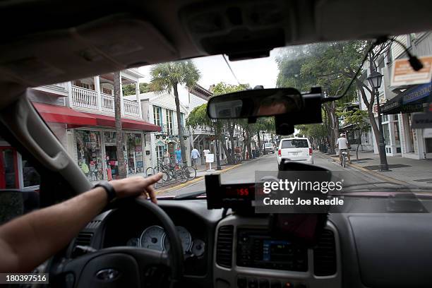 Ivan, , a taxi driver for Five 6's Taxi, drives through Duval Street on September 12, 2013 in Key West, Florida. The city recently enacted a Key West...