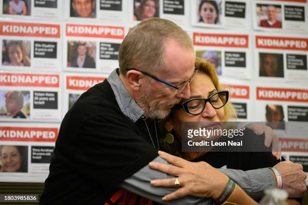 Thomas Hand , the father of Emily Hand, comforts Orit Meir , the mother of Almog Meir, as she addresses journalists during a press conference at the...