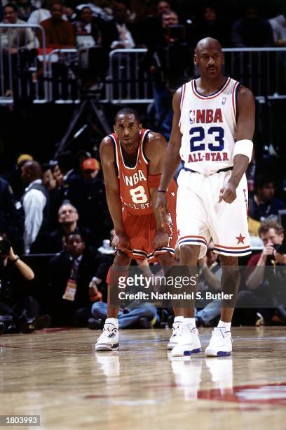 Kobe Bryant of the Western Conference All-Stars takes a moment after playing against Michael Jordan of the Eastern Conference during the 52nd NBA...