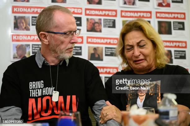 Thomas Hand , the father of Emily Hand, listens to Orit Meir , the mother of Almog Meir, as she addresses journalists during a press conference at...