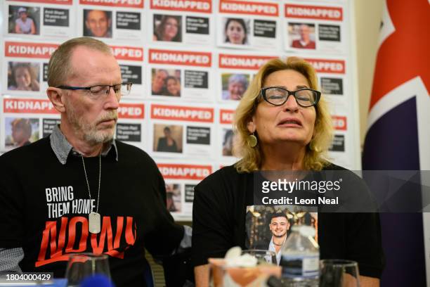 Thomas Hand , the father of Emily Hand, listens to Orit Meir , the mother of Almog Meir, as she addresses journalists during a press conference at...