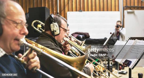 men, band and playing trumpet instrument in recording studio for performance practice, orchestra or jazz album. male people, brass device for creative audio or stage production, notes or sheet music - singing rehearsal stock pictures, royalty-free photos & images