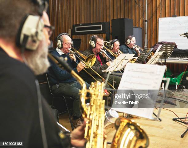 music, band and instrument with people in a recording studio, reading sheet for artist performance. concert, jazz and musician group playing as an orchestra for art, creative or sound at a showcase - brass instrument stock pictures, royalty-free photos & images