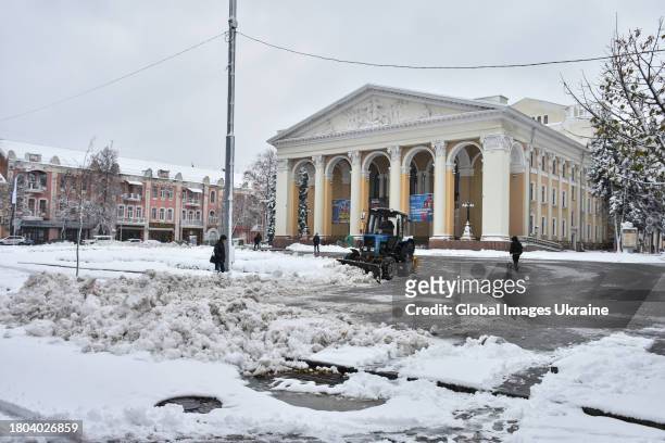Tractor removes snow on a square in front of a theater building on November 20, 2023 in Poltava, Ukraine. Since the snowfall that began on November...