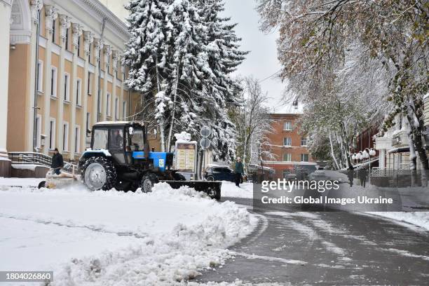 Tractor removes snow on a street on November 20, 2023 in Poltava, Ukraine. Since the snowfall that began on November 19 in Poltava Oblast, there have...