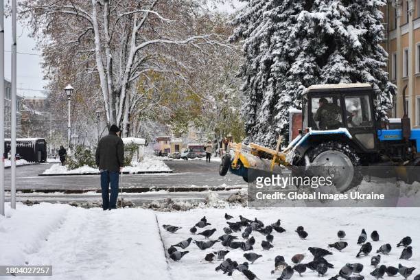 Tractor removes snow on a street on November 20, 2023 in Poltava, Ukraine. Since the snowfall that began on November 19 in Poltava Oblast, there have...