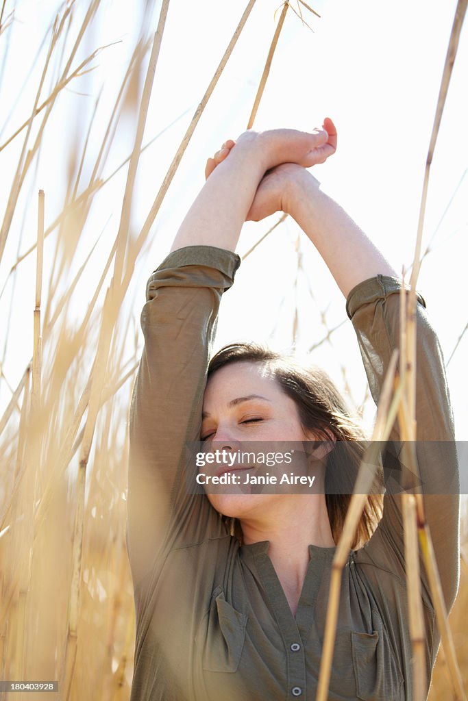 Portrait of young woman amongst reeds