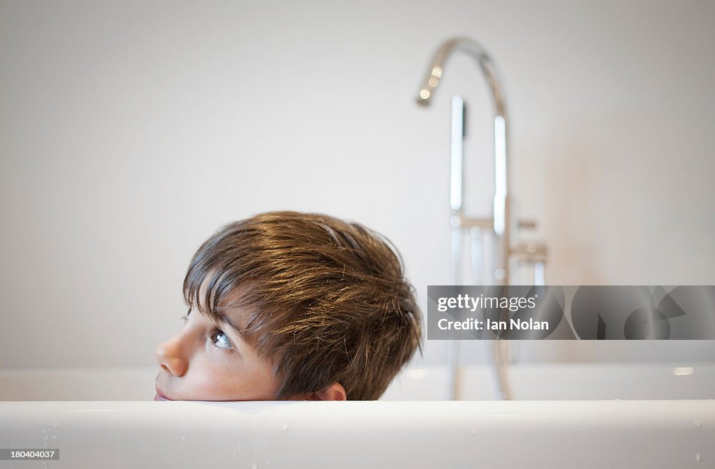 Head shot of young boy in bath