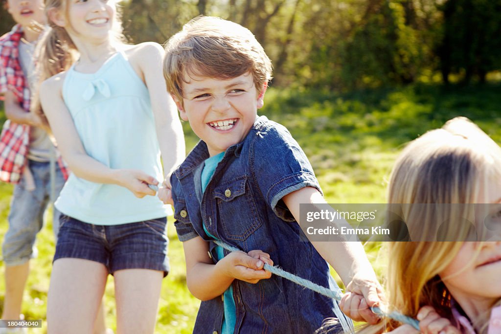 Close up of group of children playing tug o war