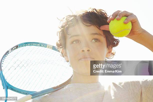 close up of boy with tennis racket and ball - attentif photos et images de collection