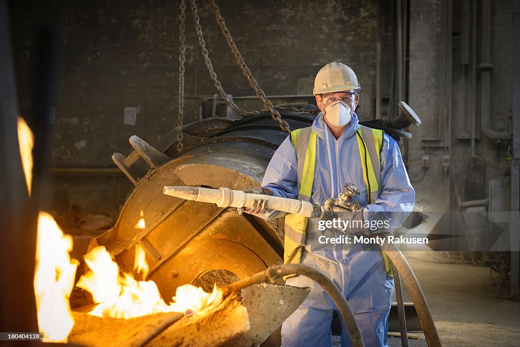 Portrait of furnace repair worker in protective clothing in steel foundry