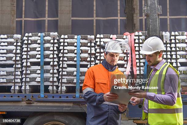 warehouse workers checking truck cargo - aluminium ingots stockfoto's en -beelden