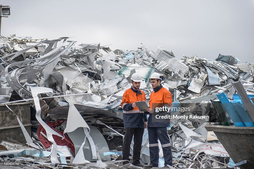 Workers inspecting scrap in aluminium recycling plant