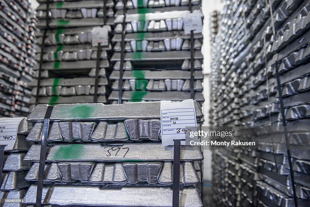 Stacked alumninium ingots in warehouse awaiting delivery