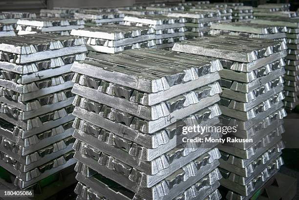 stacked ingots in aluminium recycling plant warehouse awaiting delivery - aluminium ingots stockfoto's en -beelden